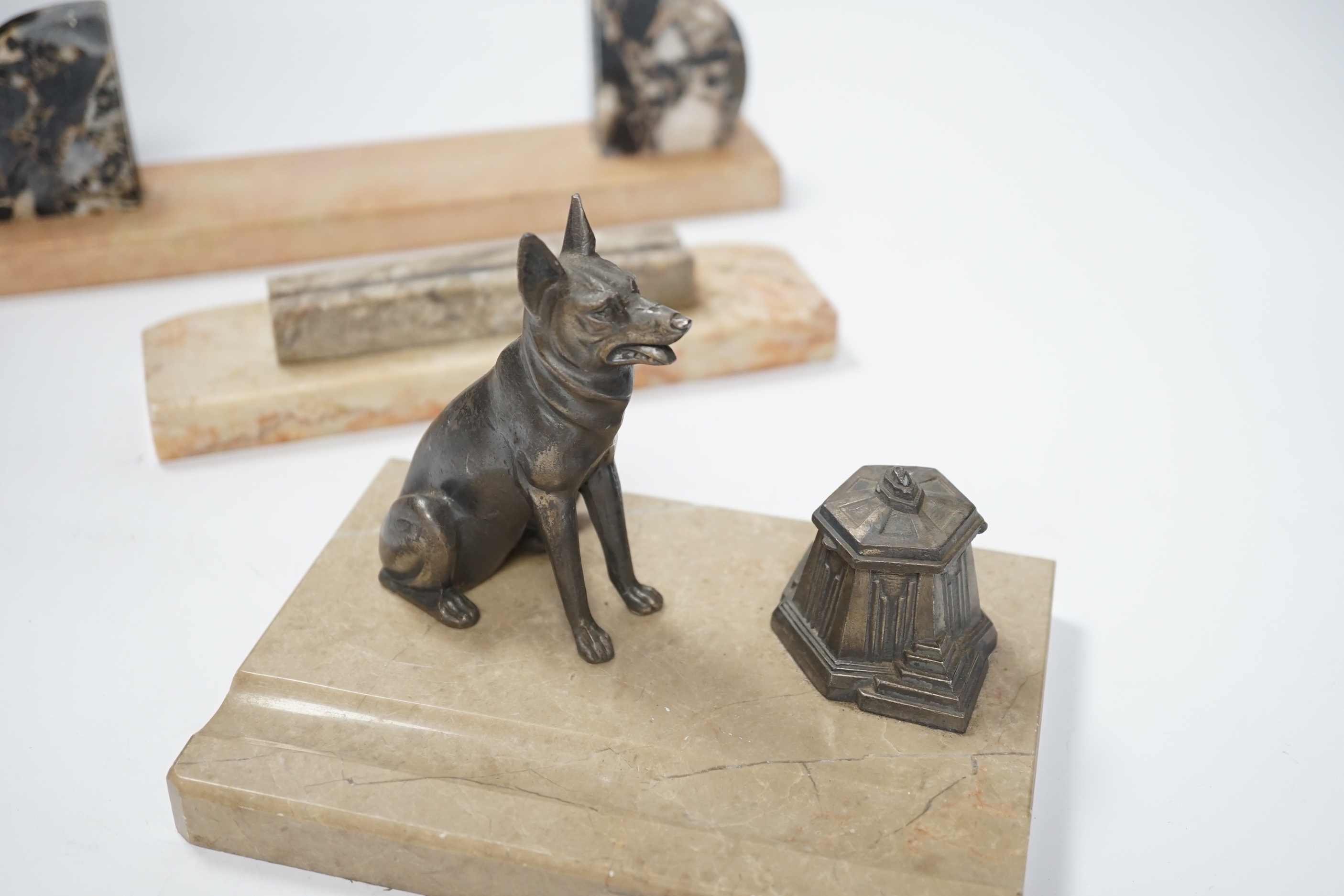 A marble and spelter Alsatian desk stand and two marble Art Deco photograph frames, largest 30cm wide